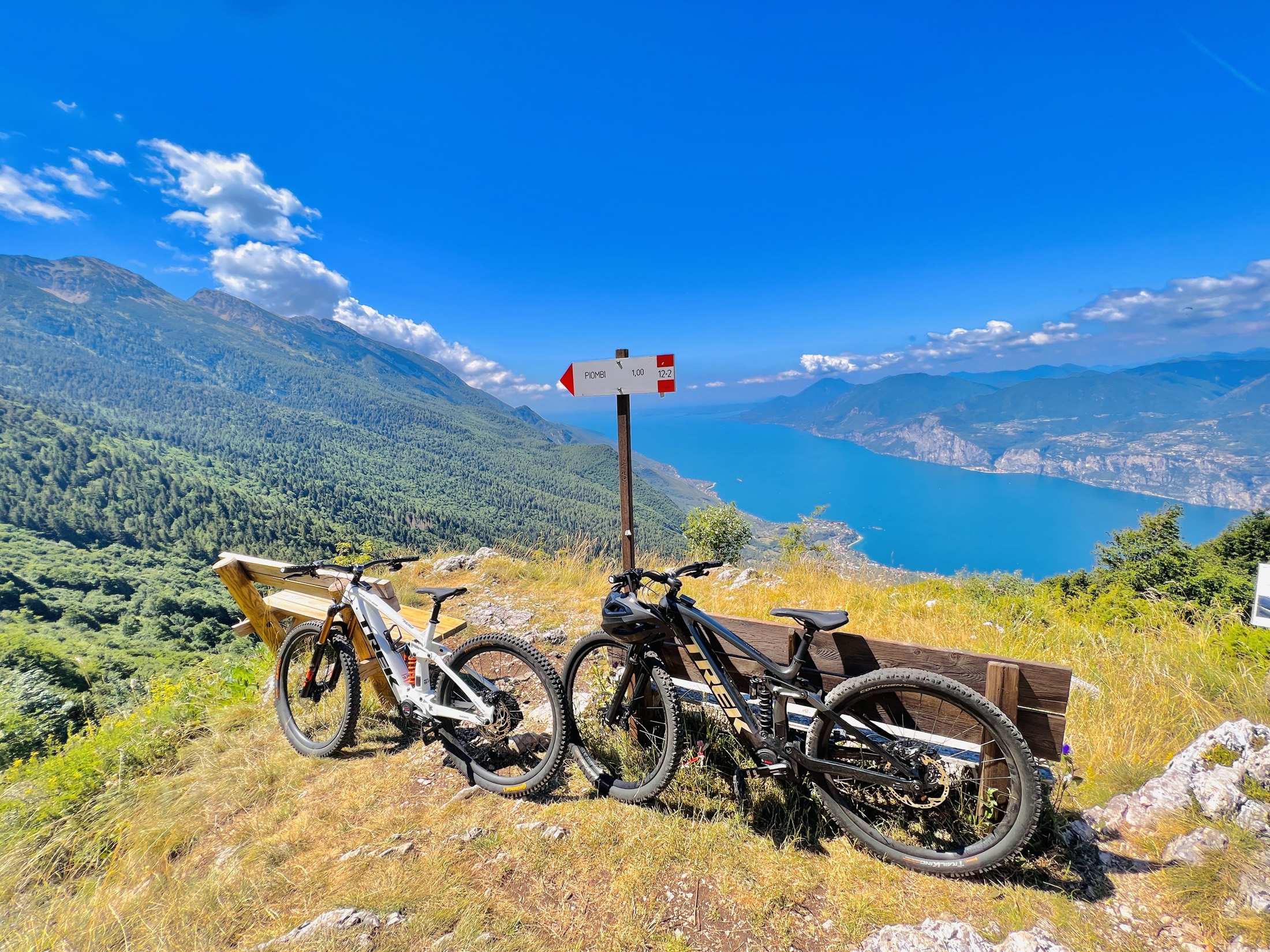 Zwei Trek Rail E-MTBs am Aussichtspunkt hoch über dem See